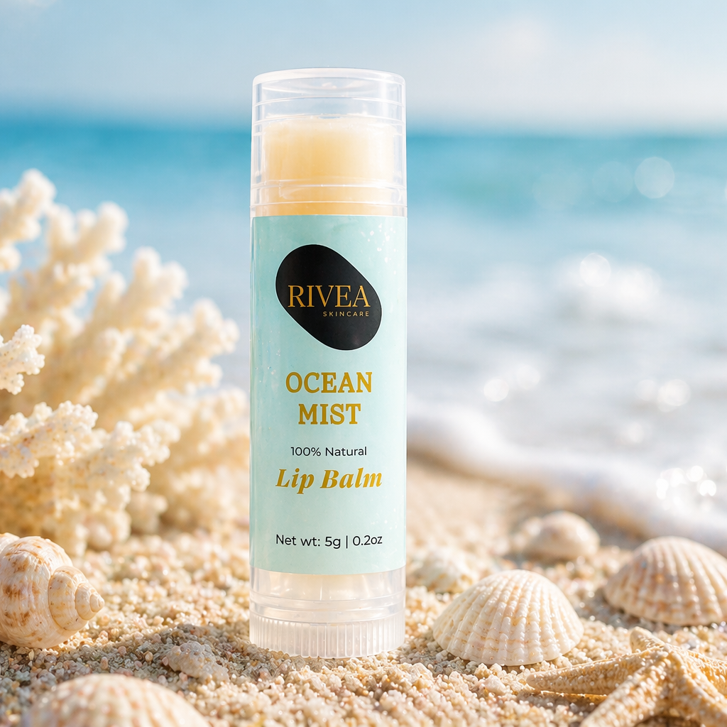 RIVEA Ocean Mist lip balm on a sandy beach with ocean view