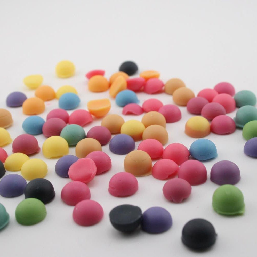 Assorted colorful round candies on a white background